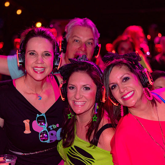 Quiet Events Silent Disco headphones for bar mitzvah.  A group of adults together posing for a picture with headphones.