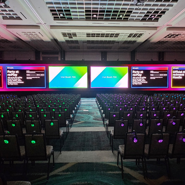 Quiet Events Silent Disco headphones for corporate gatherings a group of chairs with headphones with various large screens