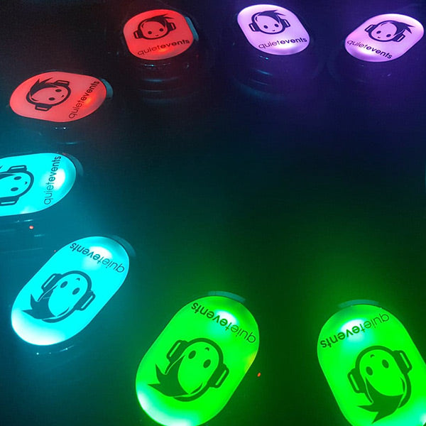 Quiet Events Silent Disco headphones for corporate gatherings a group of Headphone in a circle and lit in various colors.