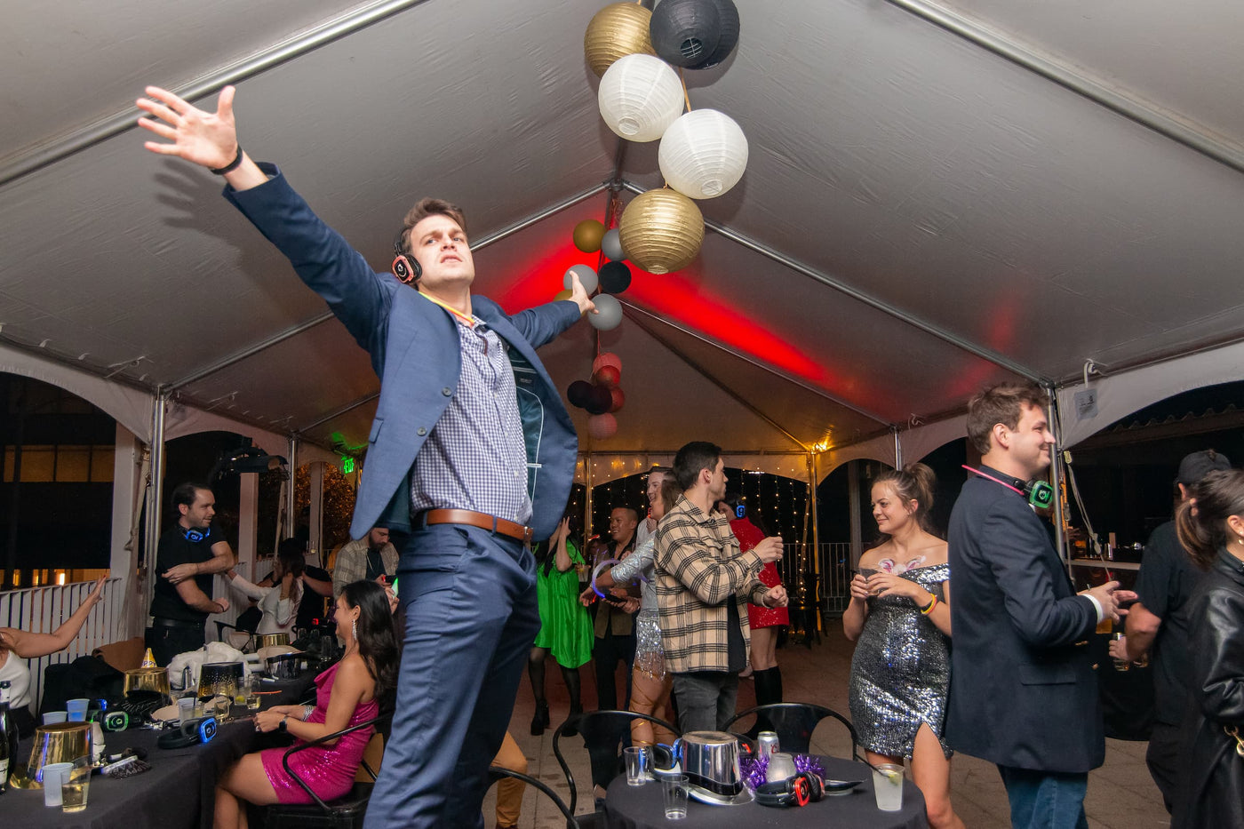 Quiet Events Silent Disco headphones for corporate.  A group of professionals having fun in a corporate party listening to music with heaadphones.
