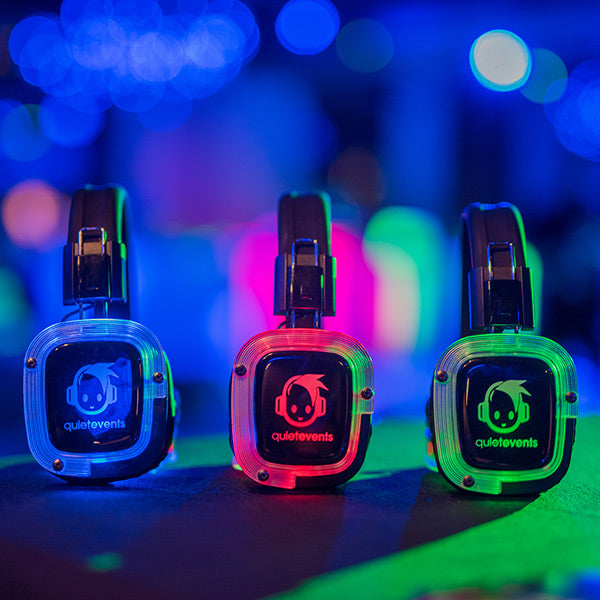 Quiet Events Silent Disco headphones for corporate gatherings and three illuminated headphones in different colors